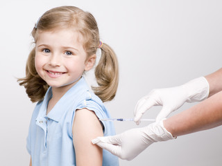 A doctor giving a child an injection