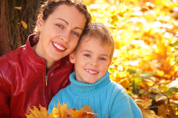 Mother and son in autumn wood