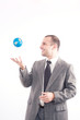 © Andreea Ardelean - Successful business man with globe over a white background