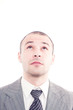© Andreea Ardelean - Successful business man looking up a white background