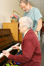 Senior Woman Pensioner Playing Piano