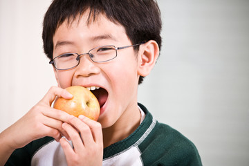 A boy eating an apple