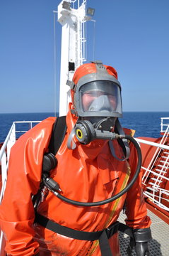 Fototapete - man in chemical suit on deck of chemical tanker