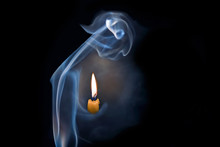 An Abstract Person From Smoke Holding A Candle