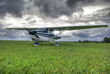 Aircraft on the field against thunderstorm clouds background