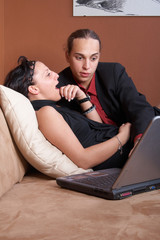 Wall Mural - Couple with laptop on couch