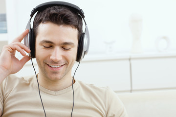 Wall Mural - Man listening music with headphones