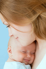 beautiful baby of three months old in his mothers hands.