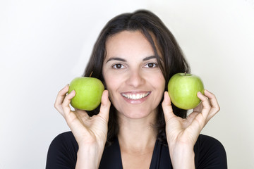 Woman with two green apples