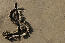 American Currency  Dollar Sign On The Beach Sand
