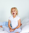 © WavebreakMediaMicro - Beautiful daughter yawning in bed