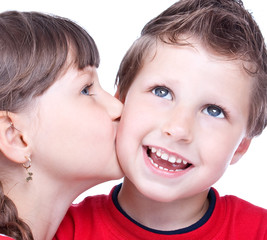 Cute girl kissing a blue eyed boy