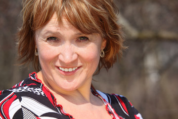 Smiling middleaged woman outdoor closeup