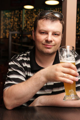 Wall Mural - The man resting with beer in a bar