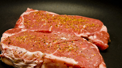 Wall Mural - Seasoned Strip Steaks in Pan