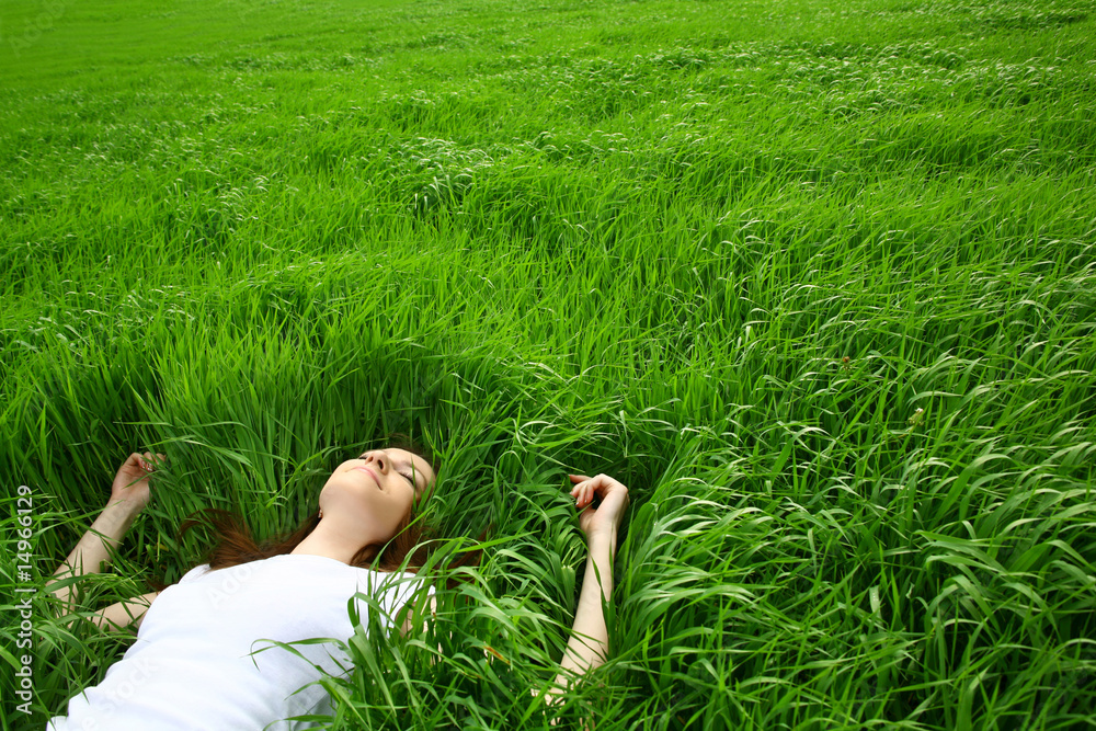 beautiful girl lying down of grass - obrazy, fototapety, plakaty 