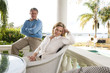 Mature couple relaxing on waterfront terrace