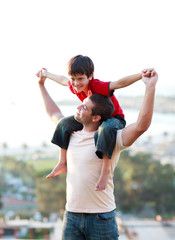 Wall Mural - Father giving his son piggyback