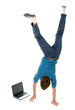 © pikselstock - Young man upside down using laptop