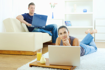 Canvas Print - Young couple working at home