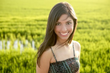 Wall Mural - Beautiful brunette indian woman in green rice fields