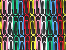 Rows Of Colorful Paper Clips On Black Card.
