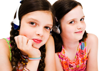 Portrait of girls listening music on headphones