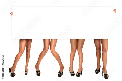 Fototapeta Womens Legs Holding up a Blank Sign