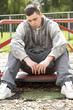 © Monkey Business - Young Man Sitting In Playground