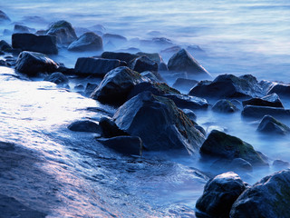 misty rocks along the coast at twilight