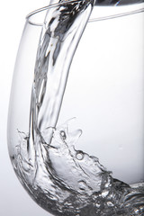 pouring water to the container with white background