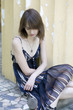 © elenarostunova - sad young woman sitting on yellow bench