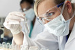 Leinwandbild Motiv Female Scientific Research Team With Clear Solution In Laborator