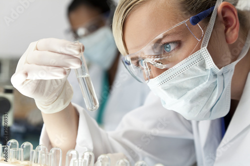 Fotografija Female Scientific Research Team With Clear Solution In Laborator