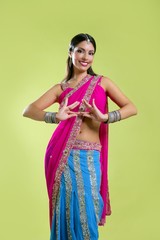 Wall Mural - Beautiful indian young brunette woman dancing