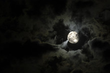 Full Moon And Eerie White Clouds Against A Black Night Sky