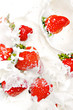 strawberries falling in cream