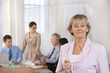 © carlosseller - Portrait of businesswoman and her colleauges.