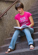 © bertys30 - teen girl with book on the stairs