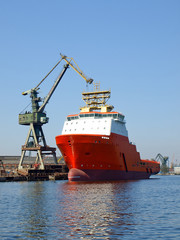 Wall Mural - Red tug in shipyard