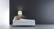 Modern white Couch to face a blank black wall - with floor lamp