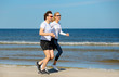 © Hanik - Couple jogging on beach