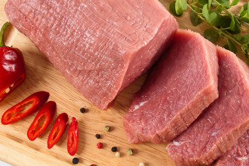 Raw beef on cutting board isolated on white background