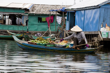Woman Selling Fruits On A Boat In Fishing Village Cambodia