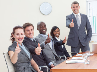 Wall Mural - Businessteam with thumbs up after a presentation