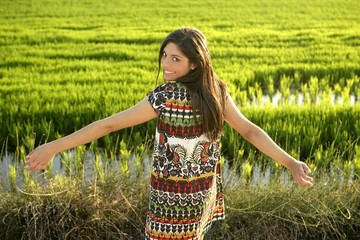 Wall Mural - Beautiful brunette indian woman in green rice fields