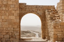 Ancient Stone Arch And Wall With Desert View During Sandstorm