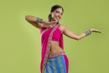 Beautiful indian young brunette woman dancing