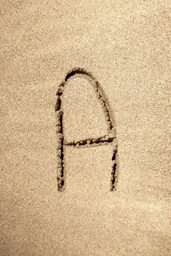 Alphabet letter A handwritten in sand