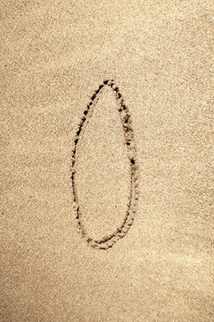 Alphabet letter O handwritten in sand